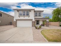 Charming two-story home with a well-manicured lawn, a two car garage, and attractive stone and stucco facade at 3841 E Esplanade Ave, Gilbert, AZ 85297