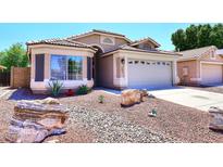 Charming single-story home featuring a well-manicured desert landscape and a two-car garage at 6603 W Saddlehorn Rd, Phoenix, AZ 85083