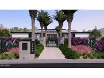 Beautiful contemporary home featuring manicured landscaping with palm trees and colorful plantings at 6649 E Ocotillo Rd, Paradise Valley, AZ 85253