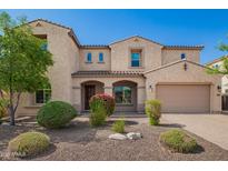 Inviting two-story home with a charming entry, desert landscaping, and a two car garage at 881 E Boston St, Gilbert, AZ 85295