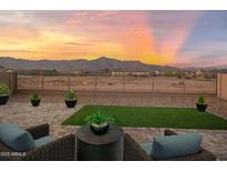 Inviting patio features cozy seating and serene views of the surrounding landscape at sunset at 11626 E Yeager Cyn, Gold Canyon, AZ 85118