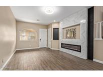 Spacious living room with a modern electric fireplace and decorative tile surround creates a cozy focal point at 1367 S Country Club Dr # 1320, Mesa, AZ 85210