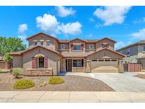 Two-story home featuring a three car garage, neutral stucco and stone accents with professionally landscaped front yard at 1526 E Glacier Pl, Chandler, AZ 85249