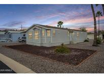 Charming mobile home with well-maintained landscaping and modern exterior at 156 N Hawes Rd # 68, Mesa, AZ 85207