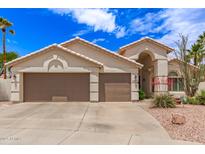 Charming single-story home featuring a three-car garage and desert landscaping at 16023 S 30Th Pl, Phoenix, AZ 85048