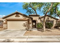 Charming single-story home featuring a two-car garage, neutral paint, stone accents and mature landscaping at 3029 N 83Rd Ln, Phoenix, AZ 85037
