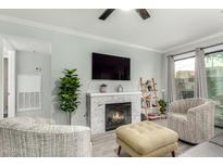 Inviting living room with a cozy fireplace and comfortable seating area at 3600 N Hayden Rd # 3405, Scottsdale, AZ 85251