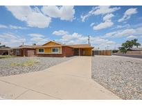 Charming brick and yellow single-story home with a well-maintained, low-maintenance front yard at 4102 W Maryland Ave, Phoenix, AZ 85019