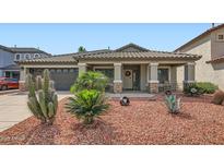 Charming single-story home featuring desert landscaping and a covered front porch at 5502 N Ormondo Way, Litchfield Park, AZ 85340