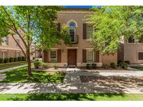 Charming two-story home with a well-manicured lawn, inviting entrance, and mature shade trees at 5757 S 21St Ter, Phoenix, AZ 85040