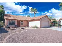 Charming single-story home with a tile roof, desert landscaping, and a two-car garage at 5941 W Venus Way, Chandler, AZ 85226