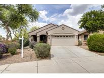 Charming single-story home with a well-manicured front yard and a two-car garage in a suburban setting at 6932 W Harwell Rd, Laveen, AZ 85339