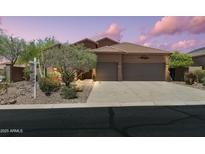 Charming home with a three-car garage, mature trees, and desert landscaping at 7144 E San Cristobal Way, Gold Canyon, AZ 85118