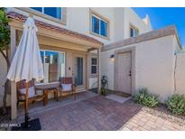 Charming outdoor patio with brick pavers, seating, and a shady umbrella for relaxing and entertaining at 7830 E Valley Vista Dr, Scottsdale, AZ 85250