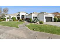 Stunning single-story home with lush green lawn and manicured landscaping at 9265 N 115Th St, Scottsdale, AZ 85259