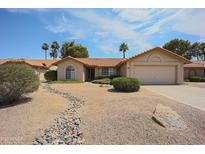 Charming single-story home with desert landscaping, a two-car garage, and a welcoming entrance at 9813 W Mcrae Way, Peoria, AZ 85382