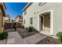 Charming home featuring a walkway leading to an arched doorway and neatly landscaped front yard at 1265 S Aaron -- # 271, Mesa, AZ 85209