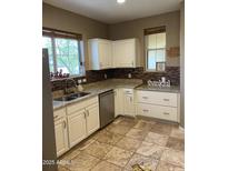 Bright kitchen featuring white cabinetry, stainless steel appliances, and granite countertops at 14575 W Mountain View Blvd # 711, Surprise, AZ 85374