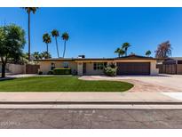 Charming single story home with landscaped front yard, desert landscaping, and brick driveway at 1535 E Kenwood St, Mesa, AZ 85203