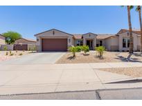 Charming single-story home featuring a two-car garage, desert landscaping, and a welcoming entrance at 15753 W Christy Dr, Surprise, AZ 85379