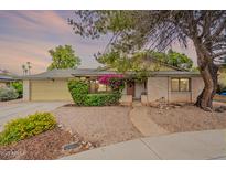 Charming single-story home featuring a landscaped front yard with mature trees and vibrant flowering bushes at 1708 E Westchester Dr, Tempe, AZ 85283