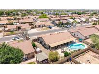 A beautiful aerial view of a home featuring a covered patio, refreshing pool, and well-maintained backyard at 1744 E Fremont Rd, Phoenix, AZ 85042