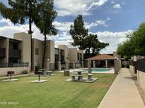 Beautiful community with pool, covered seating, mature shade trees, and barbeque grills at 1927 E Hampton Ave # 260, Mesa, AZ 85204