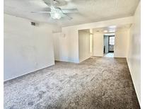 Spacious living room featuring neutral carpet and bright natural light. This room is ready for new memories at 1927 E Hampton Ave # 260, Mesa, AZ 85204