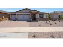Charming single-story home featuring a two-car garage, stone accents, and a well-maintained front yard at 22699 E Happy Rd, Queen Creek, AZ 85142