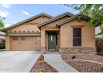 Charming single-story home with a two-car garage, stone accents, and a well-manicured front yard at 29751 N 119Th Ln, Peoria, AZ 85383