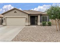 Charming single-story home featuring a well-manicured yard, neutral color scheme, and attached two-car garage at 3067 E Merlot St, Gilbert, AZ 85298