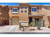 Two-story home featuring neutral stucco, a desert landscape, an attached garage, and a tiled roof at 318 S Leandro --, Mesa, AZ 85208