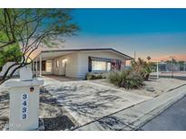 Inviting single-story home featuring covered parking, desert landscaping, and a charming mailbox with street number at 3433 E Sandra Ter, Phoenix, AZ 85032