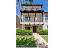 Inviting two-story home boasts a charming balcony, manicured lawn, and a welcoming entryway at 3623 E Horace Dr, Gilbert, AZ 85296