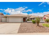 Charming single-story home with a well-manicured front yard and a two-car garage at 3701 E Morrow Dr, Phoenix, AZ 85050