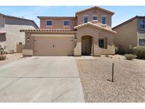 Inviting two-story home with a two-car garage, neutral paint and well-maintained landscaping at 43530 W Eddie Way, Maricopa, AZ 85138