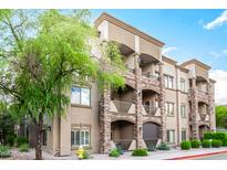 Multi-level condominium featuring stone accents, balconies, and manicured landscaping at 5350 E Deer Valley Dr # 3274, Phoenix, AZ 85054