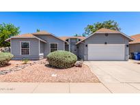 Charming single-story home featuring a desert landscape, a two-car garage, and a well-maintained yard at 6156 W Del Rio St, Chandler, AZ 85226
