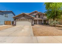 Charming two-story home featuring a desert landscape, a two-car garage and a neutral color palette at 634 W Aviary Way, Gilbert, AZ 85233