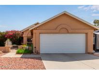 Charming home featuring a large two-car garage and desert landscaping, showcasing curb appeal at 7333 N 69Th Ave, Glendale, AZ 85303