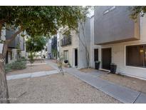 Modern townhome showcasing a concrete walkway, minimalist landscaping and corrugated metal exterior at 7857 N 21St Ave, Phoenix, AZ 85021