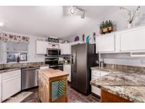 Modern kitchen featuring stainless steel appliances, white cabinets, and granite countertops at 8209 E 5Th Ave, Mesa, AZ 85208