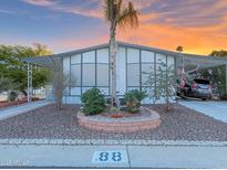 Charming home with desert landscaping, covered parking, and beautiful sunset skies at 8600 E Broadway Rd # 88, Mesa, AZ 85208