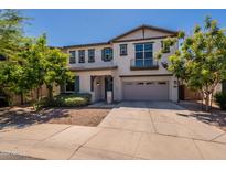 Charming two-story home featuring a well-manicured lawn, a balcony, and an attached two-car garage at 98 N Bay Dr, Gilbert, AZ 85233