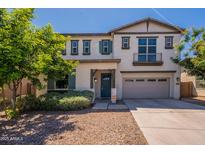 Charming two-story home boasts a landscaped yard, attached two-car garage, and an inviting front door at 98 N Bay Dr, Gilbert, AZ 85233