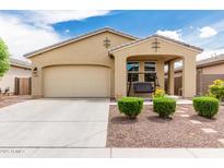 Charming single-story home featuring a covered porch with a swing and a well-maintained front yard at 12357 W Whyman Ave, Avondale, AZ 85323