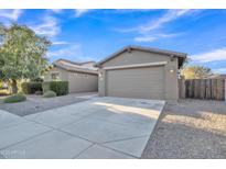 Charming single-Gathering home showcasing a well-maintained yard and two-car garage at 1258 W Plane Tree Ave, San Tan Valley, AZ 85140