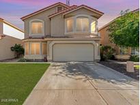 Charming two-story home with desert landscaping, arched windows, and a two-car garage at 1433 E Mineral Rd, Gilbert, AZ 85234