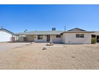 Charming single-story home featuring desert landscaping and a welcoming front patio with a decorative water fountain at 1532 W 6Th St, Tempe, AZ 85281