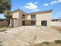 View of the home's backyard, showcasing the patio and upper balcony at 15650 N 19Th Ave # 1206, Phoenix, AZ 85023